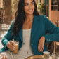 Model wearing Seamless SeamSoft™ Summer Oversize Blazer in green at sunlit Egyptian summer café