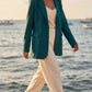 Seamless SeamSoft™ Summer Oversize Blazer in green styled with cream trousers, Mediterranean coast
