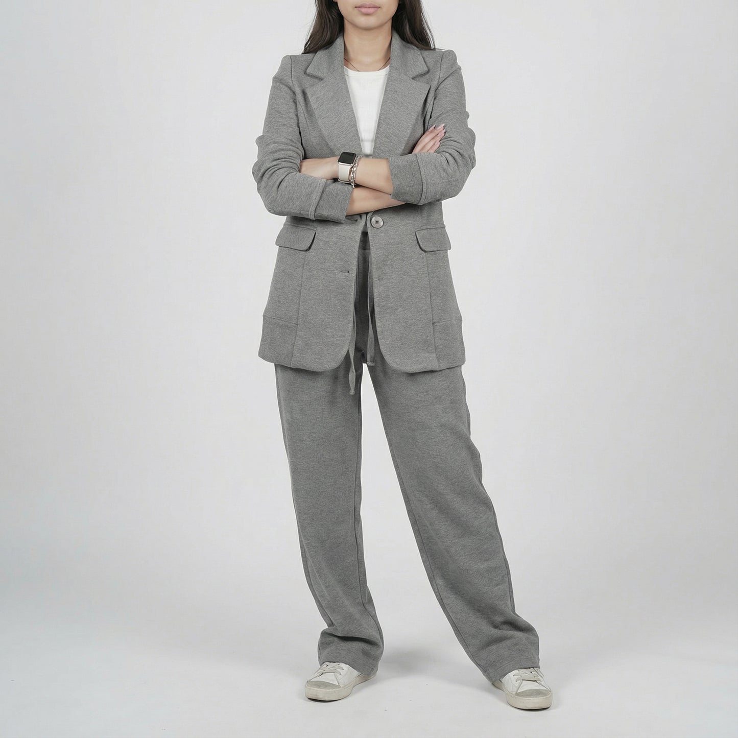 Person wearing a gray suit on a white background