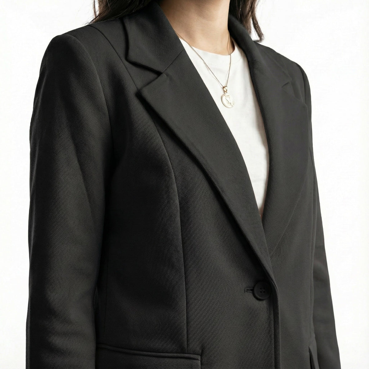 Black blazer worn by a person on a white background