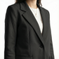 Black blazer worn by a person on a white background