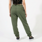 Person wearing olive green sweatpants on a white background